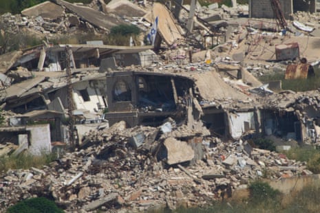 An Israeli flag hangs on a destroyed building in southern Lebanon as seen from northern Israel.