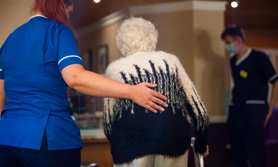 Staff helping a resident in a care home