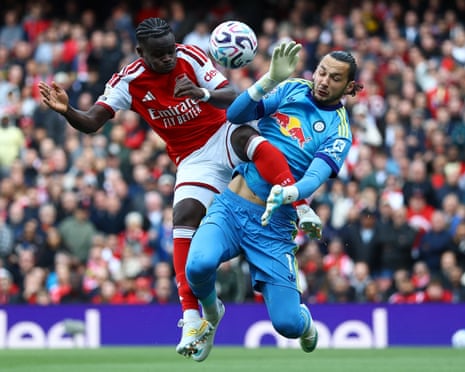 Arsenal's Bukayo Saka collides with Leeds United's keeper James Trafford.