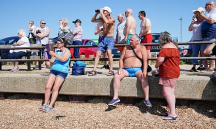 People watch the Ever Given arrive at the Port of Felixstowe in Suffolk