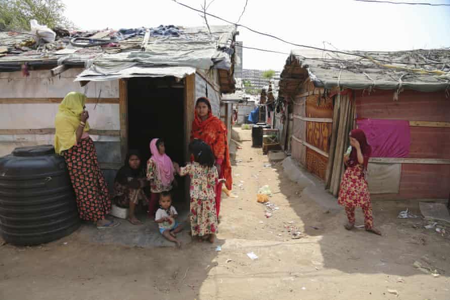 Rohingya refugees stand outside a makeshift camp on the outskirts of Jammu, India, in March 2021.