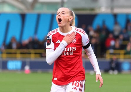 Chloe Kelly celebrates scoring Arsenal’s second goal against her former club by holding the badge on her shirt