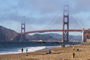 San Francisco, US. People on Baker beach near the Golden Gate Bridge as a heatwave continues