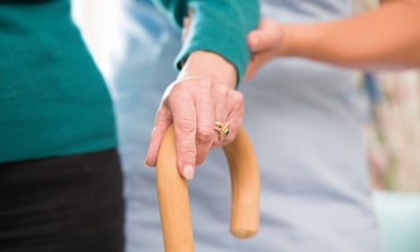 A care worker assists an elderly woman