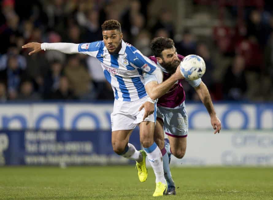 Elias Kachunga battles for the ball with Mile Jedinak during Huddersfield’s victory over Aston Villa in March.
