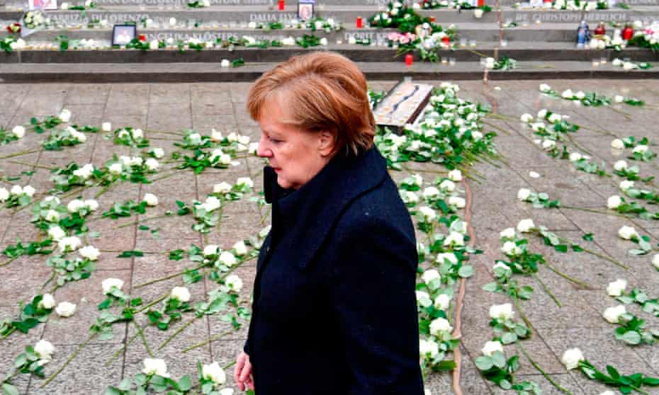 Angela Merkel walks past the memorial for victims of last year’s truck attack at Breitscheidplatz Christmas market in Berlin.