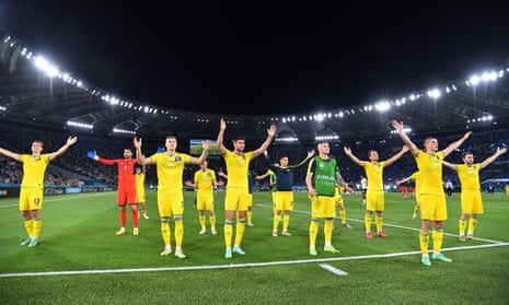 Ukraine players gesture to fans after the match.