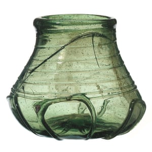 A decorated green glass beaker from the burial chamber likely to have been made in Kent.