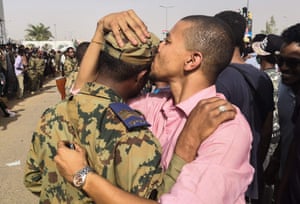 A Sudanese anti-regime protester warmly greets a soldier during protests.