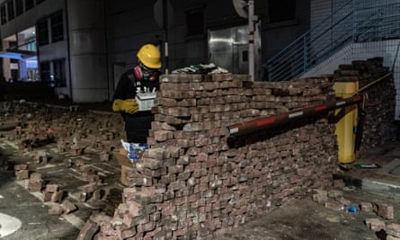 A pro-democracy protester builds a brick wall during a demonstration at the Chinese University of Hong Kong.