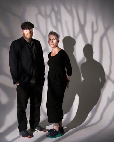 Franke Boyle and Denise Mina in front of a wall shadowed by tree branches.