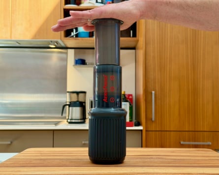 A person making coffee with an aeropress go