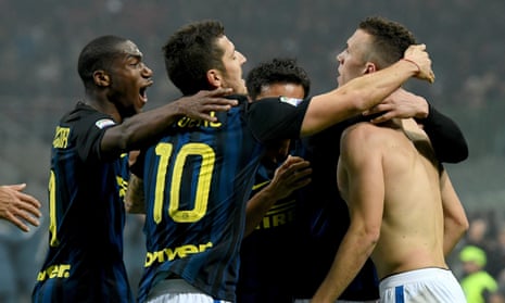 Ivan Perisic, right, is mobbed his Internazionale team-mates after scoring an injury-time equaliser against Milan.