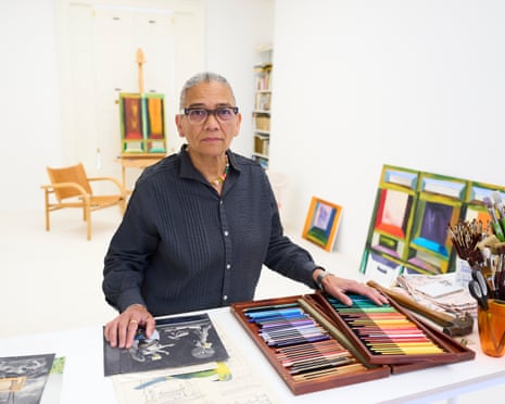Artist Lubaina Himid in her Preston studio with colored pencils and artwork.