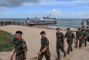 The French navy’s naval riflemen in camouflage uniform walk up the beach from the sea