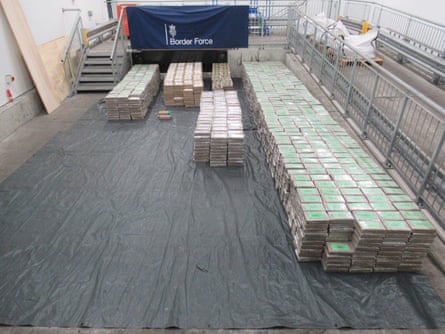 Very ample number of bricks of narcotics each lined up connected a grey tarpaulin wrong a warehouse
