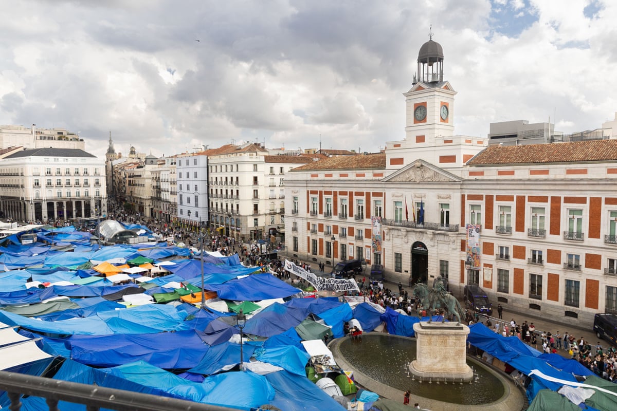 An urban plaza in Madrid filled with tents