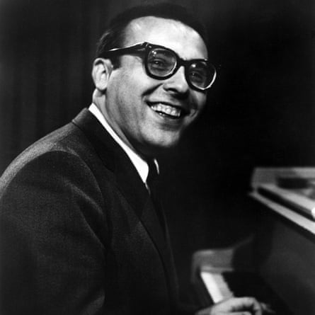 Black-and-white portrait of Vince Guaraldi sitting at a piano