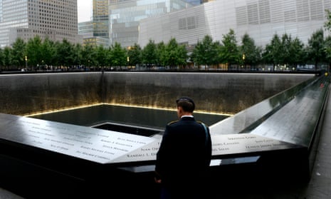 A member of the US military looks out at the South Pool at the National September 11 Memorial, in downtown Manhattan.