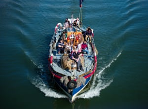 A boat taking tourists on a trip around Whitby Bay on the Yorkshire coast returns to the harbour as the UK's warm weather continues