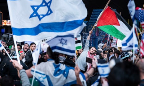 People gathered for a rally in support of Palestine face a rally across the street in support of Israel, near Times Square in New York.