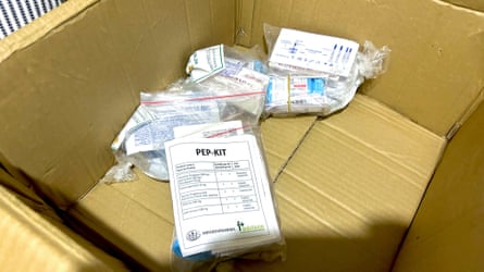 Plastic bags containing medicine bottles in a brown cardboard box.