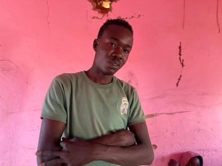 A worried-looking young African man with his arms folded