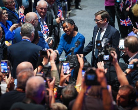 Photographers and delegates clamour to get a picture of Kemi Badenoch.
