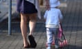 A woman and a toddler pushing a toy stroller