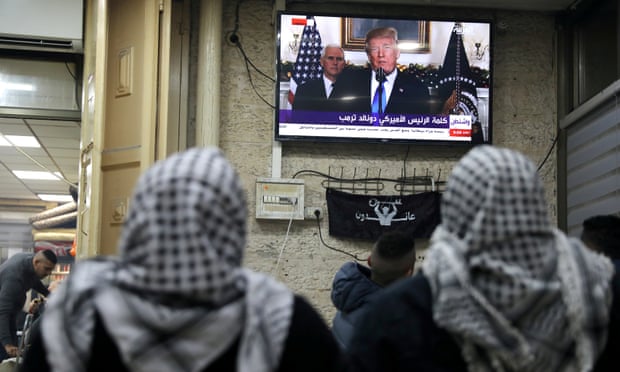 Palestinians watch a televised broadcast of Trump announcing US recognition of Jerusalem as the capital of Israel, in Jerusalem’s Old City.