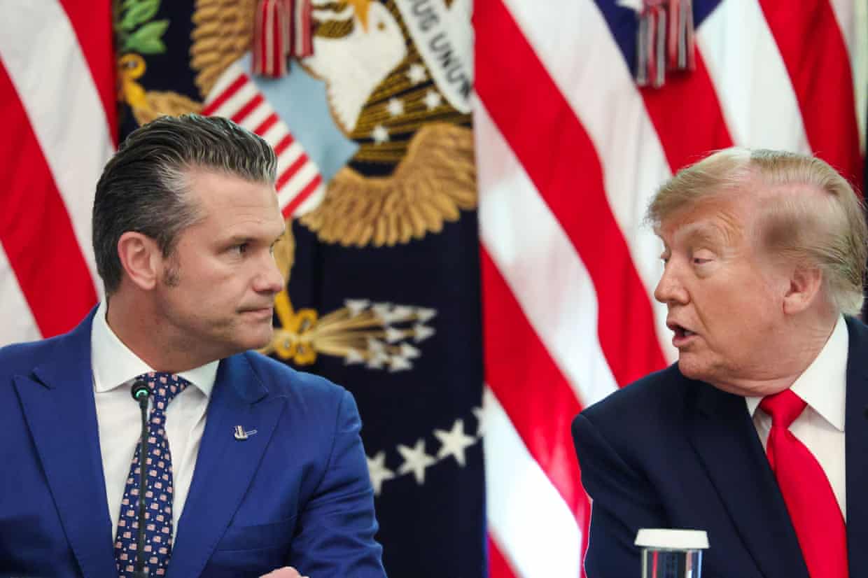 Pete Hegseth listens as Donald Trump speaks, seated together with American flags behind them