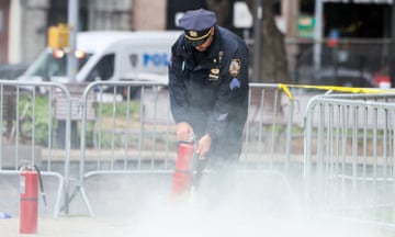 A police officer uses a fire extinguisher