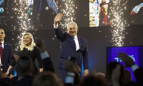 Israel’s Prime Minister Benjamin Netanyahu and Likud party leader and his wife Sara wave to his supporters.