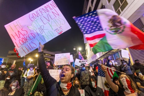 Demonstrators hold signs and flags during a protest following federal immigration operations in Los Angeles on June 9, 2025.