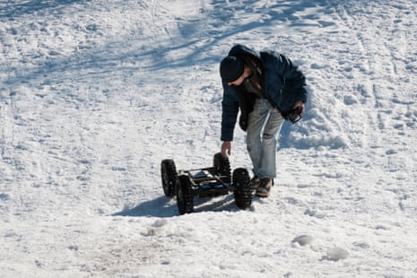 A volunteer tests equipment in a snowy landscape