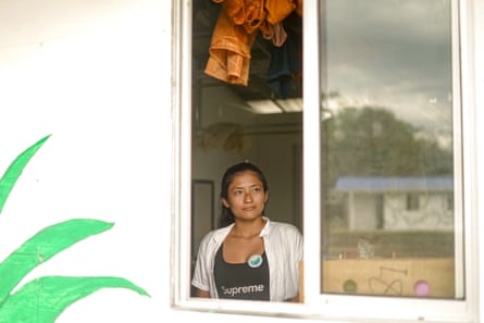 Natalia Briñez, a former guerrilla fighter, is one of 13 women in the ZUT. She is seen looking through a window of one of the peace zone huts.