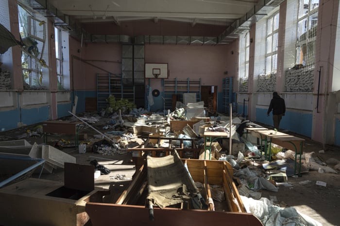 A man walks through the sports gym in the school which was used as a Russian military hospital in the recently retaken area of Izium.