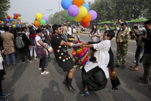 Two participants hold hands and dance as gay rights activists and their supporters march during a gay pride parade in New Delhi