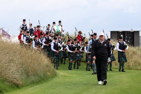 Donald Trump walking in front of a pipe band, on the day of the opening of Trump Golf Links Aberdeen in Balmedie, Aberdeen.
