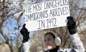 A
        protester holds a sign near the White House to protest President
        Donald Trump’s travel ban.