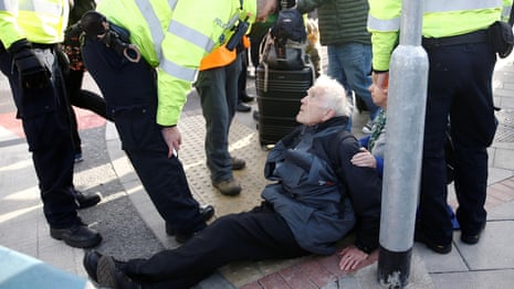 Extinction Rebellion protester, 83, arrested at London City airport – video