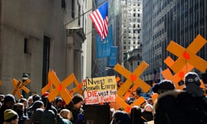 A divest from fossil fuel demonstration in front of the New York stock exchange, Wall Street, New York.