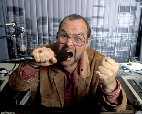 James Whale holding a microphone during a broadcast of his show in the 80s