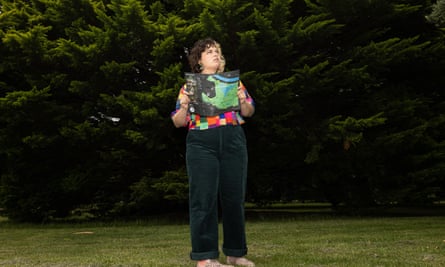 Matilda Boseley with a map in front of trees 