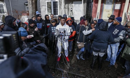 Activists, family and neighbors gather to speak to the media after the shooting.