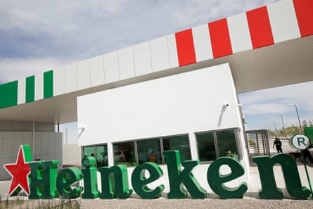 The entrance to an industrial site with a large Heineken sign