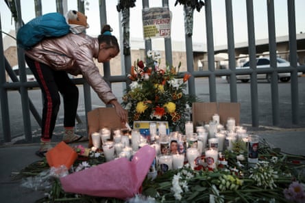 A girl lights candle during a vigil for the victims of the immigration center fire.