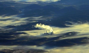 A coal fired power station shrouded in morning mist