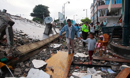 People walk among the debris after a 7.8 magnitude earthquake hit the north coast of Ecuador.