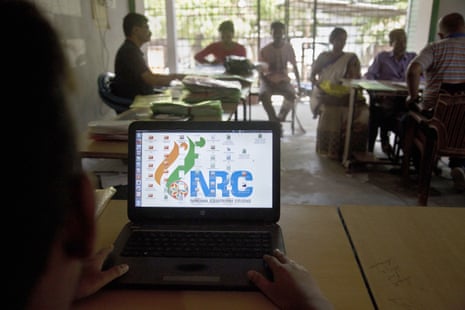 National Register of Citizens officers attend to customers at an centre in Guwahati, India, on 30 August.